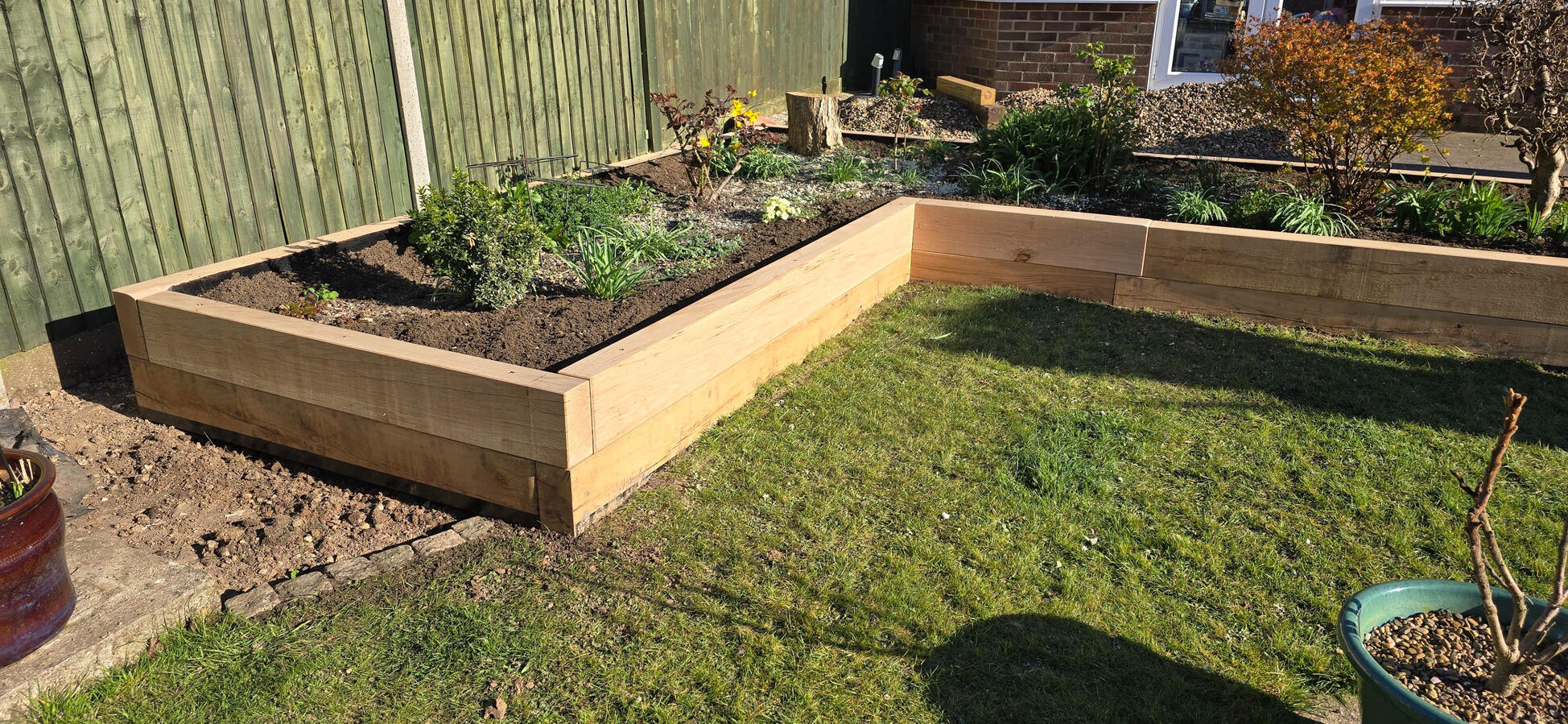 Oak Sleepers in Waterlooville Raised sleeper bed constructed by MJA Garden Landscaping, supplied by Equestrian Fencing in Wickham.